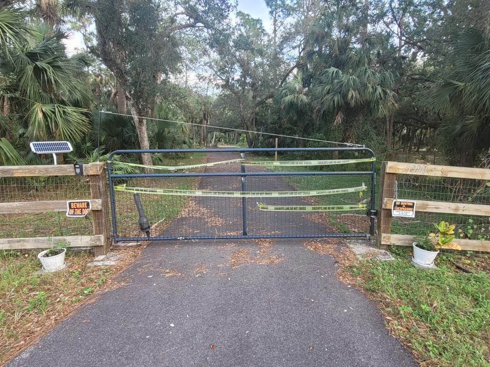 Crime scene tape on gate outside of Baunach residence