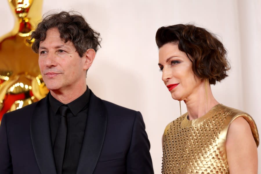 HOLLYWOOD, CALIFORNIA – MARCH 10: (L-R) Jonathan Glazer and guest attends the 96th Annual Academy Awards on March 10, 2024 in Hollywood, California. (Photo by Mike Coppola/Getty Images)