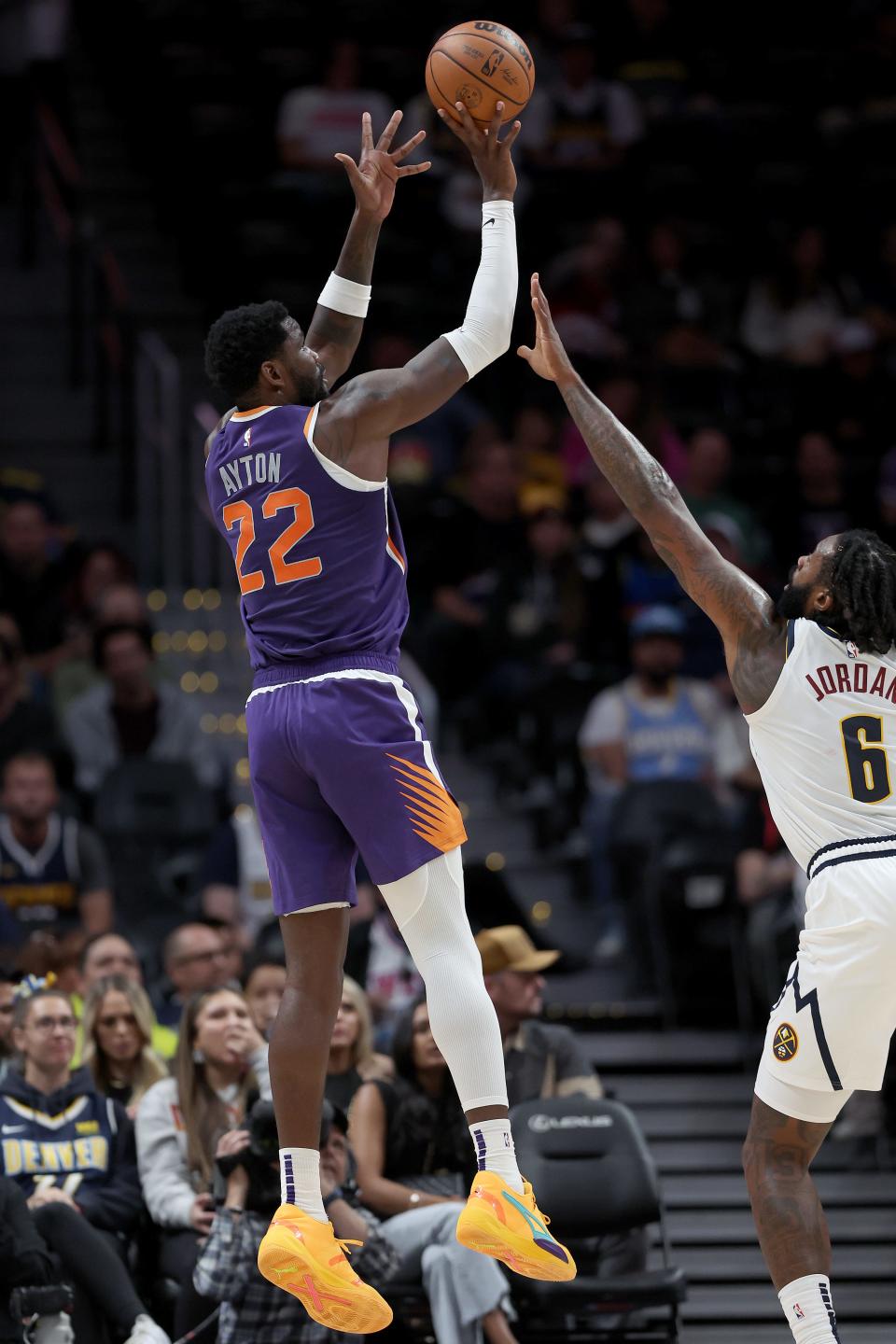 DENVER, COLORADO - OCTOBER 10: Deandre Ayton #22 of the Phoenix Suns puts up a shot over DeAndre Jordan #6 f the Denver Nuggets in the first quarter during a preseason game at Ball Arena on October 10, 2022 in Denver, Colorado. (Photo by Matthew Stockman/Getty Images)