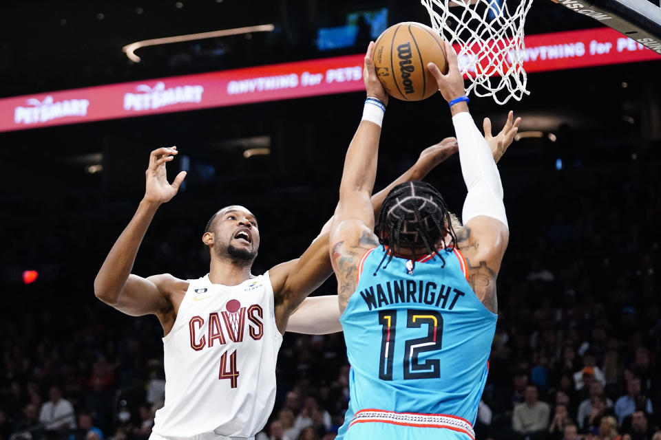 Phoenix Suns' Ish Wainwright (12) grabs a rebound over Cleveland Cavaliers' Evan Mobley (4) during the first half of an NBA basketball game in Phoenix, Sunday, Jan. 8, 2023. (AP Photo/Darryl Webb)