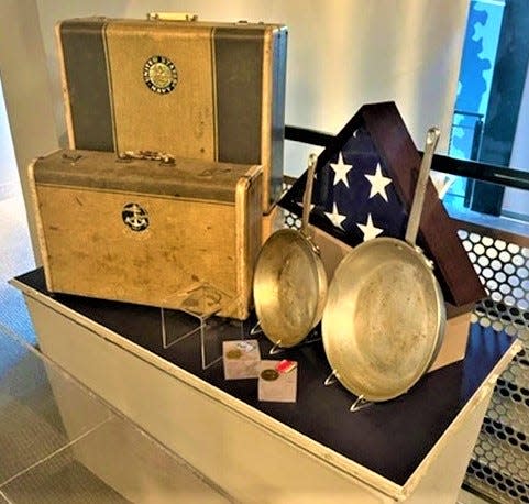 Estelle Busch Leinen's suitcases from her service in the Navy WAVES and her burial flag, and Lavern Leinen's Navy cooking pans are among the items on display in a new exhibit at the Sullivan Brothers Iowa Veterans Museum.