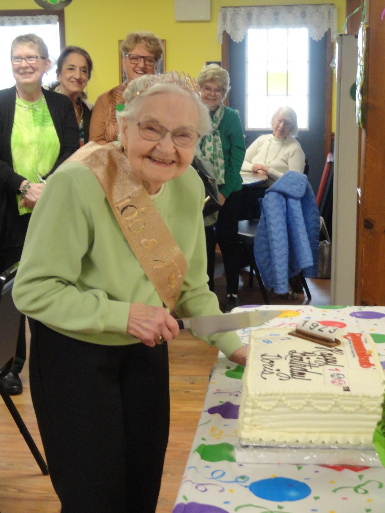 Mrs. Doris Day slices her cake at her 100th birthday party at the Honesdale Senior Center on March 17. Day was born March 16, 1923.