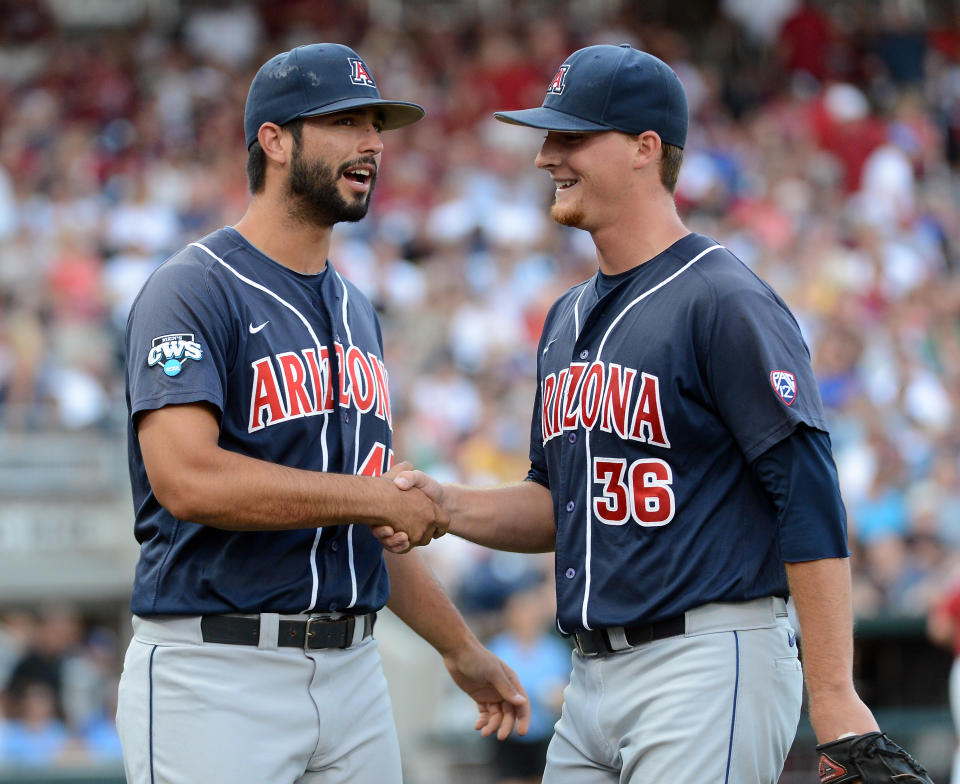 OMAHA, NE - JUNE 25: James Farris #36 of the Arizona Wildcats reacts with Michael Lopez #45 to after an out to end the third inning against the South Carolina Gamecocks during game 2 of the College World Series at TD Ameritrade Field on June 25, 2012 in Omaha, Nebraska. (Photo by Harry How/Getty Images)