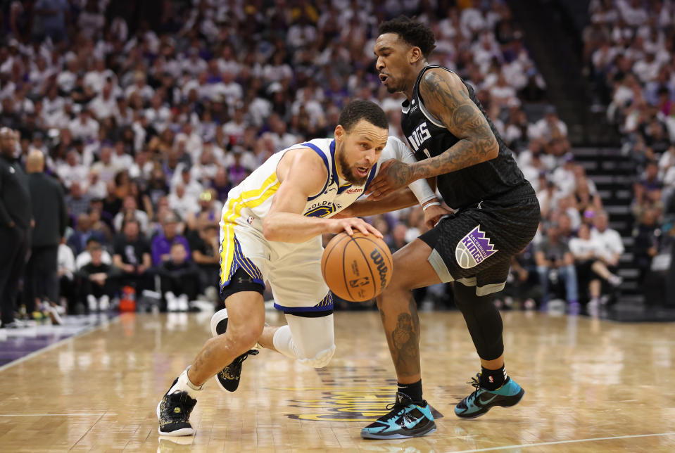 SACRAMENTO, CALIFORNIA - APRIL 30: Stephen Curry #30 of the Golden State Warriors dribbles against Malik Monk #0 of the Sacramento Kings during the fourth quarter in game seven of the Western Conference First Round Playoffs at Golden 1 Center on April 30, 2023 in Sacramento, California. NOTE TO USER: User expressly acknowledges and agrees that, by downloading and or using this photograph, User is consenting to the terms and conditions of the Getty Images License Agreement. (Photo by Ezra Shaw/Getty Images)