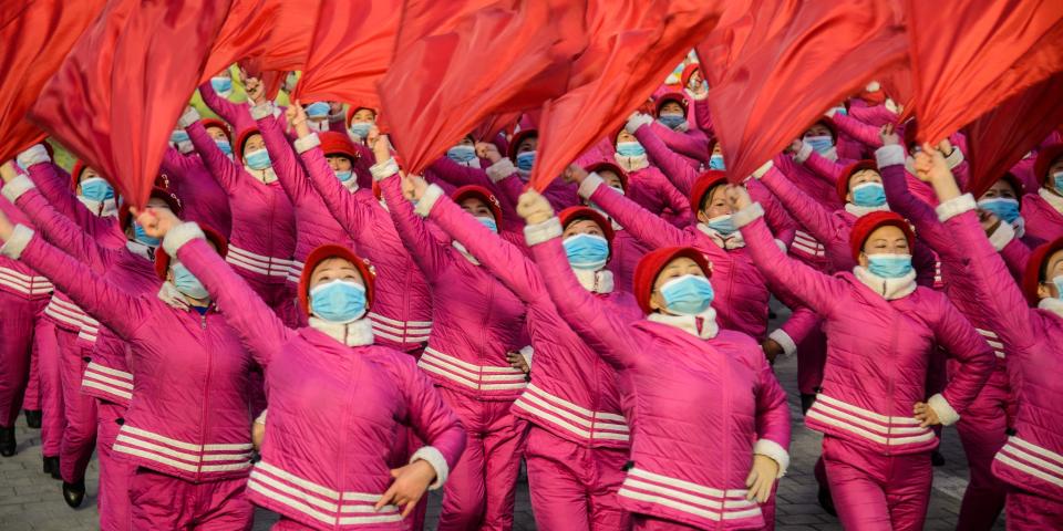 TOPSHOT - In this picture taken on January 5, 2022, people take part in a demonstration march after the Pyongyang City rally to carry out the decision of the 4th Plenary Meeting of the 8th Central Committee of the Workers' Party of Korea, at Kim Il Sung Square in Pyongyang. (Photo by KIM Won Jin / AFP) (Photo by KIM WON JIN/AFP via Getty Images)