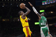 Atlanta Hawks guard Delon Wright (0) shoots over Boston Celtics guard Dennis Schroder (71) during the second half of an NBA basketball game Friday, Jan. 28, 2022, in Atlanta. (AP Photo/Hakim Wright Sr.)