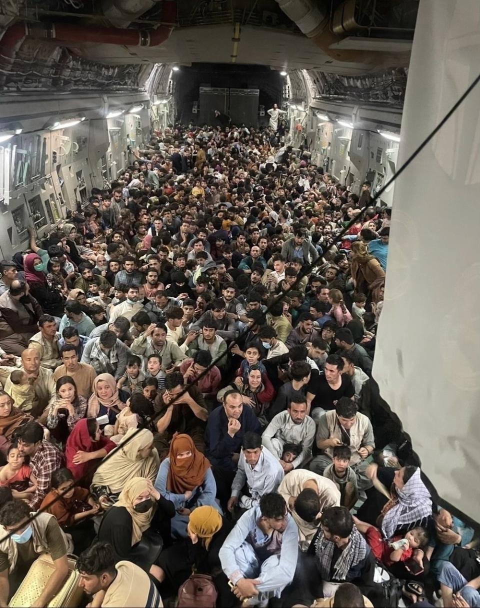 The inside of a military aircraft crammed with Afghans fleeing the country
