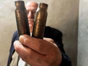 Haider Mohamed Khaled displays shell casings, he said he found in his house in Sararo village, following Turkish bombardments last spring on the area, in Dohuk
