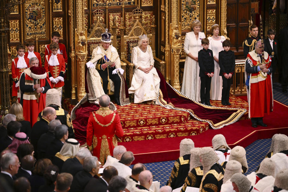 FILE - Britain's King Charles III, center left, next to Queen Camilla, reads out a speech, written by Prime Minister Rishi Sunak's government, outlining its legislative plans, during the State Opening of Parliament at the Houses of Parliament, in London, on Nov. 7, 2023. (Leon Neal/Pool Photo via AP, File)