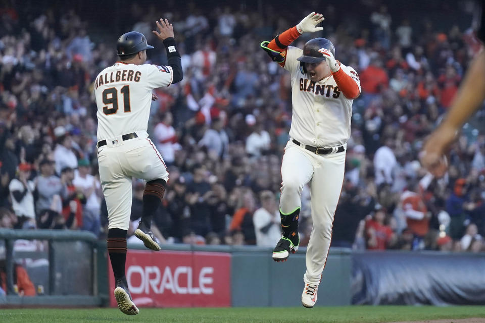 San Francisco Giants' Joc Pederson, right, celebrates with third base coach Mark Hallberg (91) after hitting a home run against the Colorado Rockies during the fifth inning of a baseball game in San Francisco, Sunday, Sept. 10, 2023. (AP Photo/Jeff Chiu)