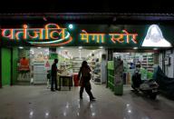 Customers walk outside a Patanjali store in Ahmedabad