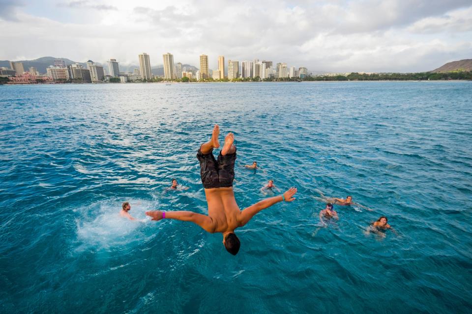 Guy flipping into water in Honolulu