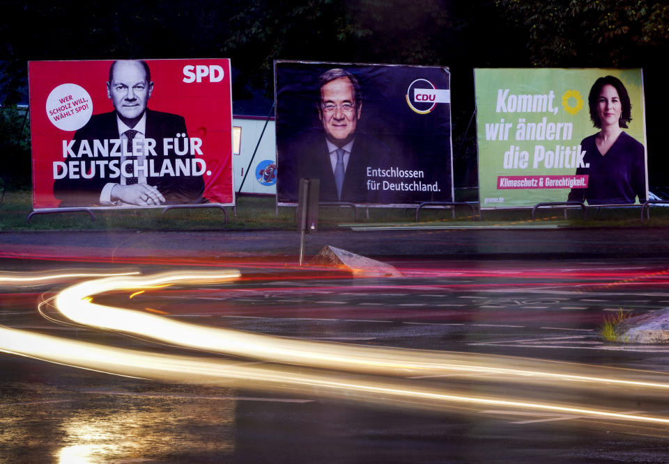 Three elections posters show Social Democratic top candidate for chancellor Olaf Scholz, left, Christian Democratic top candidate Armin Laschet, center, and top candidate of the Greens Annalena Baerbock in Frankfurt, Germany, Wednesday, Sept. 15, 2021. Letters read "Chancellor for Germany" for Scholz, "determined for Germany" for Scholz and "come we change politics" for Baerbock. Germany prepares for the Sept. 26 election that will determine who succeeds Chancellor Angela Merkel at the helm of Europe’s biggest economy. While some of the issues that voters say are most important to them, including climate change and the economy, are global or national in scope, the splintered election campaign has meant many are judging Germany's next leader by focusing on intensely local and personal questions. (AP Photo/Michael Probst)