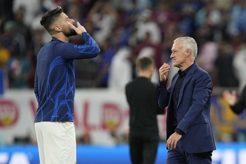 France's Olivier Giroud, left, and France's head coach Didier Deschamps celebrate winning the World Cup round of 16 soccer match between France and Poland, at the Al Thumama Stadium in Doha, Qatar, Sunday, Dec. 4, 2022. (AP Photo/Martin Meissner)