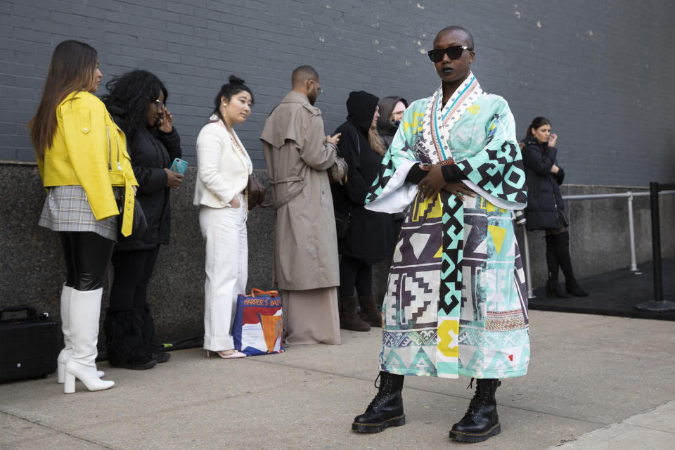 Sabrina-Anne Sarpong, founder of British media platform DSTNGR, poses for photographers outside a show during Fashion Week, Wednesday, Feb. 12, 2020, in New York. (AP Photo/Mark Lennihan)