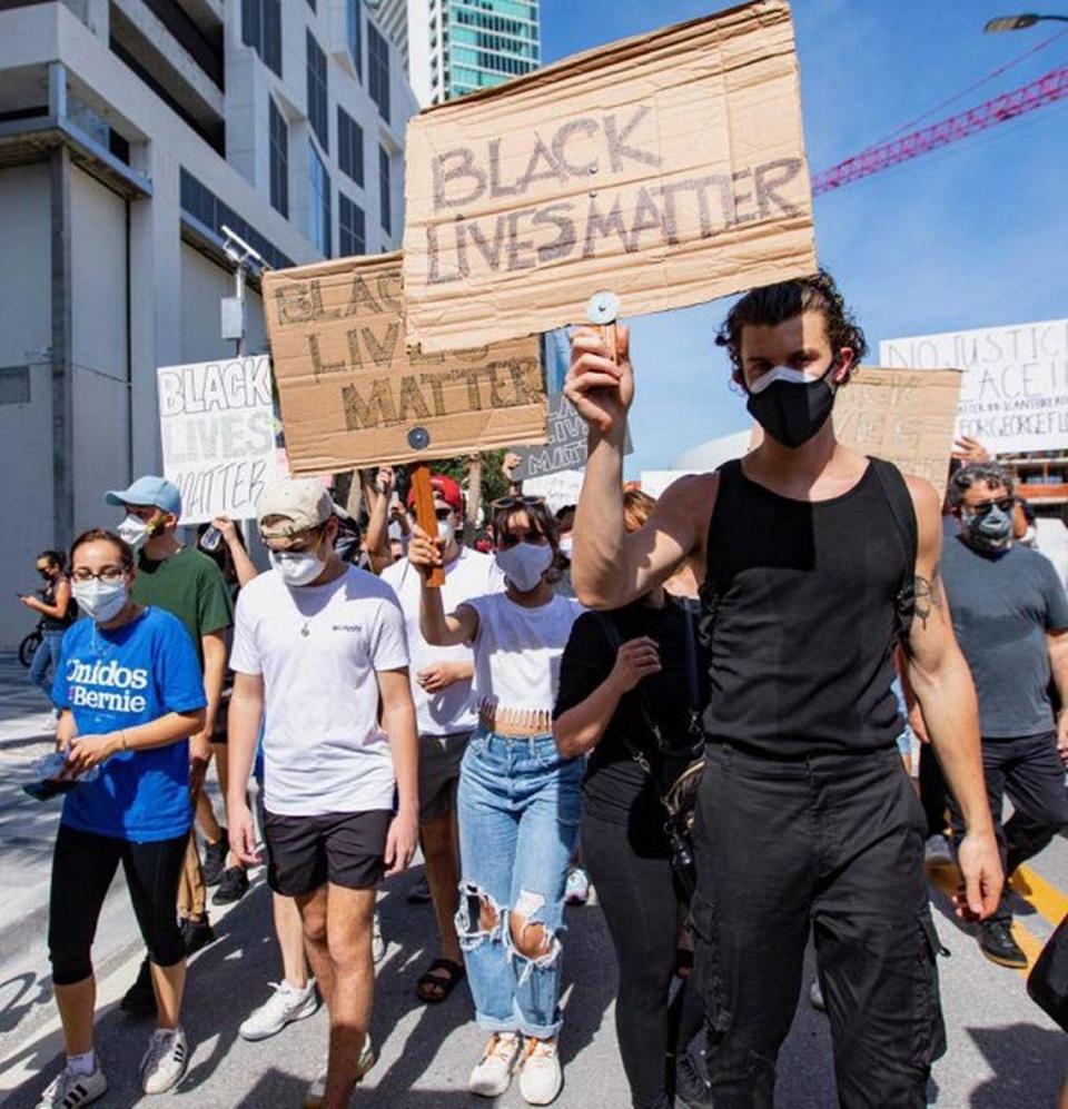 Celebrity couple Camila Cabello and Shawn Mendes hold “Black Lives Matter” signs during the second day of the “Justice for George Floyd” protests in Downtown Miami, Florida on Sunday, May 31, 2020.