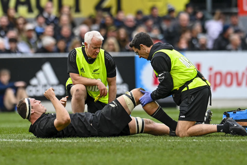 New Zealand's Brodie Retallick receives treatment to a knee injury during the Bledisloe Cup rugby test match between the All Blacks and Australia in Dunedin, New Zealand, Saturday, Aug. 5, 2023. (John Davidson/Photosport via AP)
