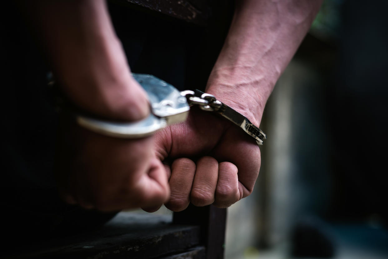 Man on the chair in handcuffs. (PHOTO: Getty Images)