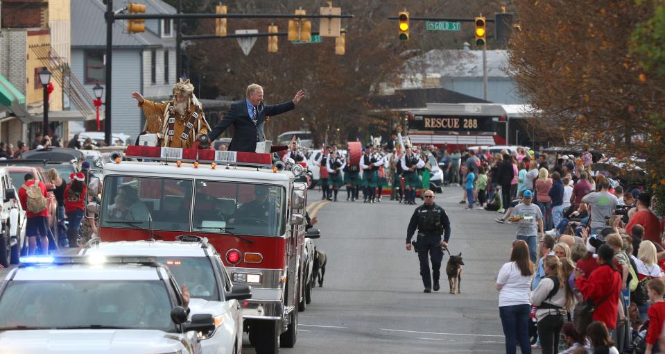 Kings Mountain Mayor Scott Neisler waves to the crowd as hundreds of people lined the streets during the annual Kings Mountain Christmas Parade on South Battleground Avenue Saturday afternoon, Dec. 4, 2021.