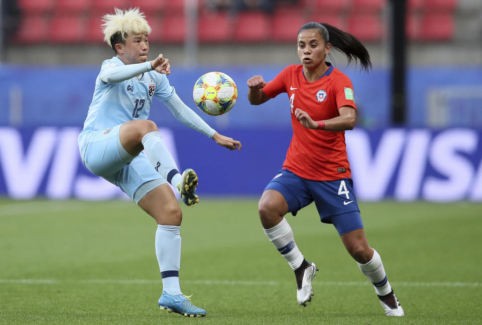 Thailand's Rattikan Thongsombut controls the ball ahead of Chile's Francisca Lara, right, during the Women's World Cup Group F soccer match between Thailand and Chile at the Roazhon Park in Rennes, France, Thursday, June 20, 2019. (AP Photo/David Vincent)