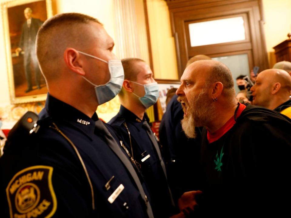 Protesters against Gov Whitmer’s policies to contain the pandemic at Michigan’s state capitol in Lansing in April 2020 (AFP via Getty Images)