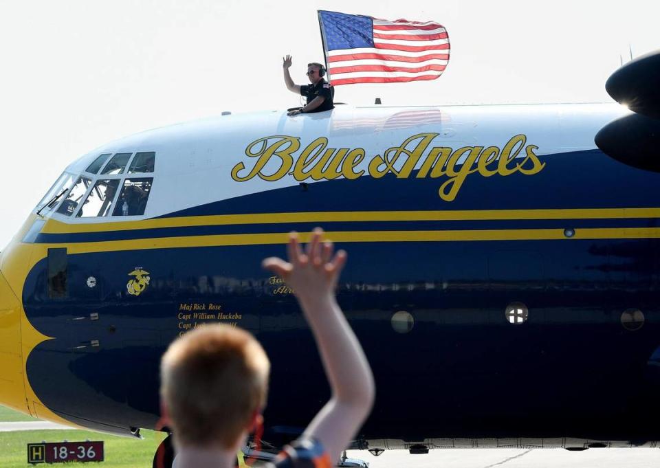 After the Navy parachute team Leap Frogs performed, “Fat Albert,” the pilot of the C-130 plane that carried them, made a pass and waved at spectators on the second and final day of the 2021 Kansas City Airshow at the New Century AirCenter in New Century, Kansas, July 4, 2021.