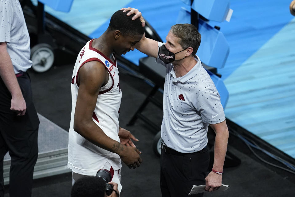 Arkansas head coach Eric Musselman, right, celebrates with guard Davonte Davis after a Sweet 16 game against Oral Roberts in the NCAA men's college basketball tournament at Bankers Life Fieldhouse, Saturday, March 27, 2021, in Indianapolis. Arkansas won 72-70. (AP Photo/Darron Cummings)