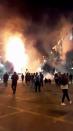 Fire emerge from the corporate building of the multinational energy company Enel in the midst of protest against subway fare hikes in Santiago