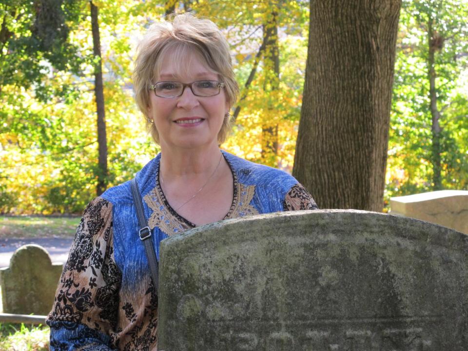 In this Oct. 18, 2013 photo, Susan Laclair of Granby, Conn., is pictured at historic Sleepy Hollow Cemetery in Sleepy Hollow, N.Y. The village of Sleepy Hollow is even busier than usual this Halloween, thanks to a new "Sleepy Hollow" TV series inspired by the tale of the Headless Horseman. "We were watching the show, and I was remembering the old story I'd read as a kid. I love anything to do with history, and I said, ‘There's a real Sleepy Hollow. Let's go for a few days, " said Laclair. (AP Photo/Jim Fitzgerald)