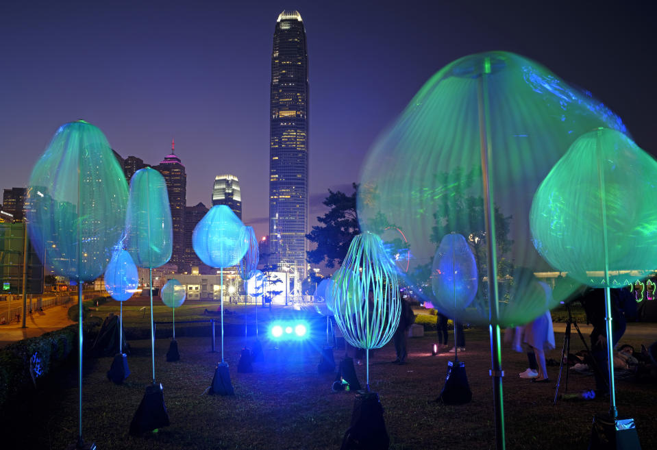 In this Saturday, Dec. 1, 2018, file photo, an installation for the Hong Kong Pulse Light Festival is lit up against the Central business center in Hong Kong. (AP Photo/Vincent Yu, File)