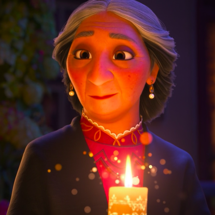 Abuela Alma holding the magical candle