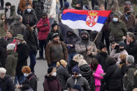 Environmental demonstrators block a highway during a protest in Belgrade, Serbia, Saturday, Jan. 15, 2022. Hundreds of environmental protesters demanding cancelation of any plans for lithium mining in Serbia took to the streets again, blocking roads and, for the first time, a border crossing. Traffic on the main highway north-south highway was halted on Saturday for more than one hour, along with several other roads throughout the country, including one on the border with Bosnia. (AP Photo/Darko Vojinovic)