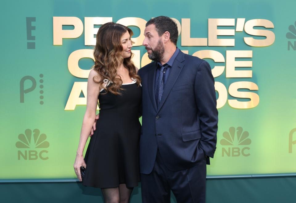 Jackie Sandler and Adam Sandler attend the 2024 People’s Choice Awards at Barker Hangar on February 18, 2024 in Santa Monica, California [Photo by Monica Schipper/Getty Images].