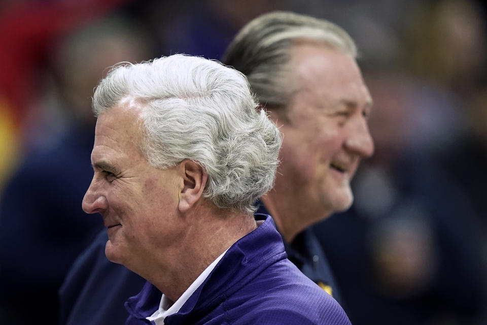 Kansas State coach Bruce Webber, front, passes West Virginia coach Bob Huggins before an NCAA college basketball game in the first round of the Big 12 Conference tournament in Kansas City, Mo., Wednesday, March 9, 2022. (AP Photo/Charlie Riedel)