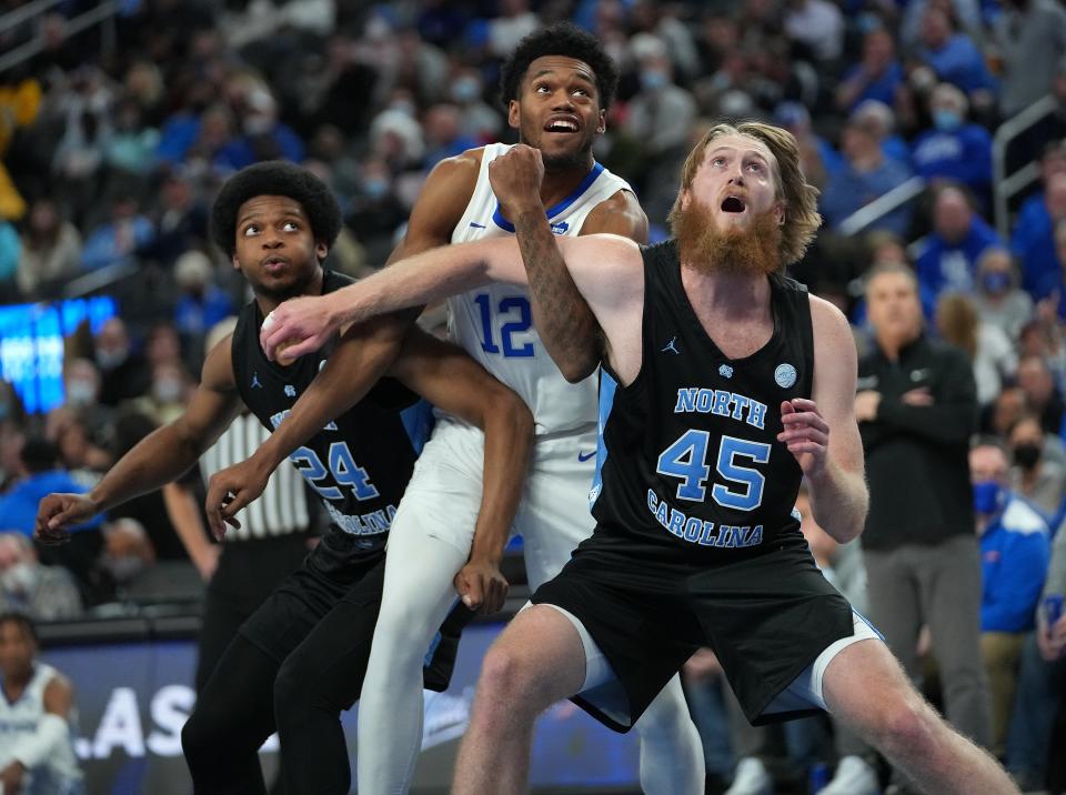 North Carolina’s Kerwin Walton, left, and Brady Manek, right, try to prevent Kentucky’s Keion Brooks Jr. from grabbing a rebound last month in Las Vegas.