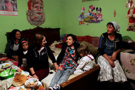 (L to R) Narghita Dinu, Anca Nica, Mihaela Dragan and Cipi Dinu talk after a performance of Povestea Cristinei (Cristina's story), a forum theatre play directed by Dragan, and organised by Roma feminist NGO E-Romnja, at the home of Narghita Dinu, in Valea Seaca, Romania, April 16, 2016. REUTERS/Andreea Campeanu