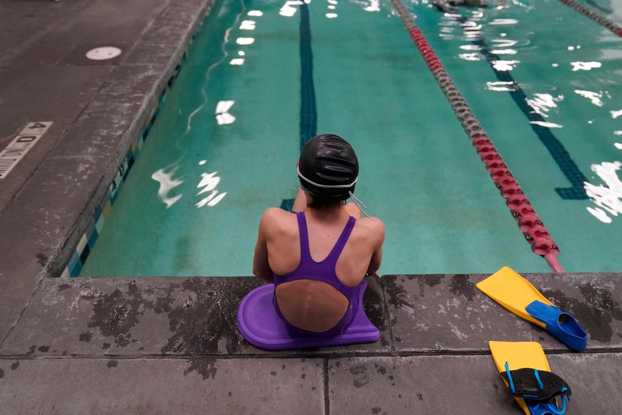 A 12-year-old transgender swimmer waits by a pool in Utah.