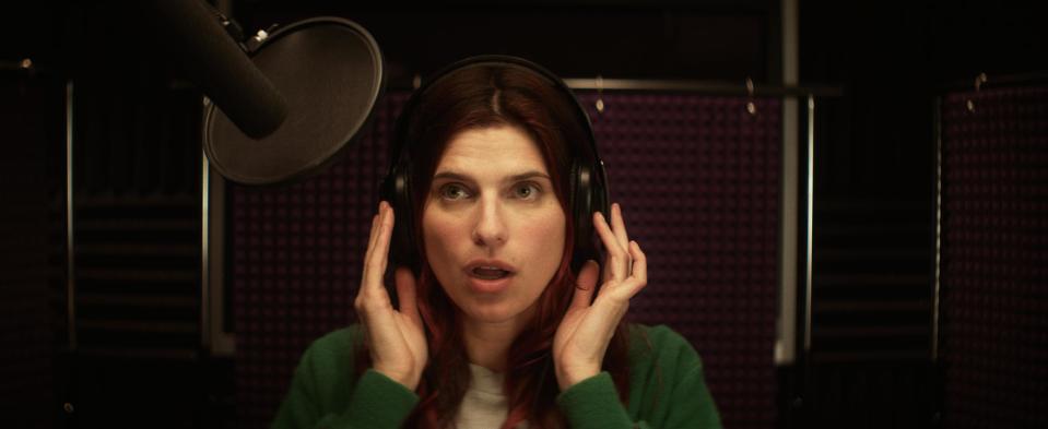 This publicity photo released by Roadside Attractions shows Lake Bell in a scene from the film "In a World...," a comedy about a struggling voice coach. Written and directed by Bell, who also stars in the film, it won the Sundance 2013 Waldo Salt Screenwriting Award for the script. Real voice-over artists, the men and women who’ve spent years invisibly announcing the latest Taco Bell temptation, the promise of Firestone tires or upcoming Lifetime programs, who’ve seen the film (which expands to more than 30 locations Aug. 16, 2013) say it’s great to watch their profession on screen. (AP Photo/Roadside Attractions, Seamus Tierney)