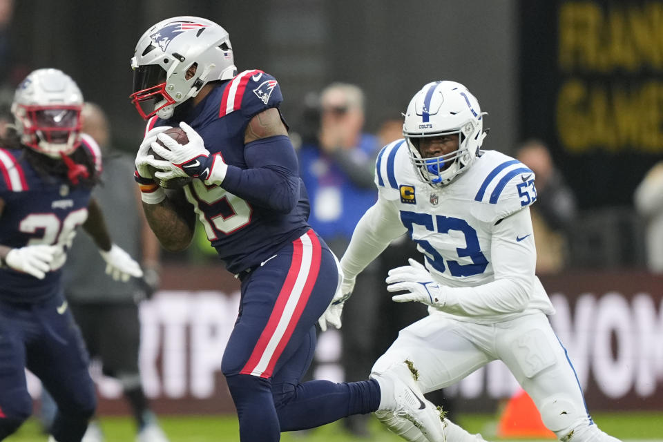 New England Patriots running back Ezekiel Elliott (15) pulls in a pass reception as Indianapolis Colts linebacker Shaquille Leonard (53) covers in the first half of an NFL football game in Frankfurt, Germany Sunday, Nov. 12, 2023. (AP Photo/Martin Meissner)