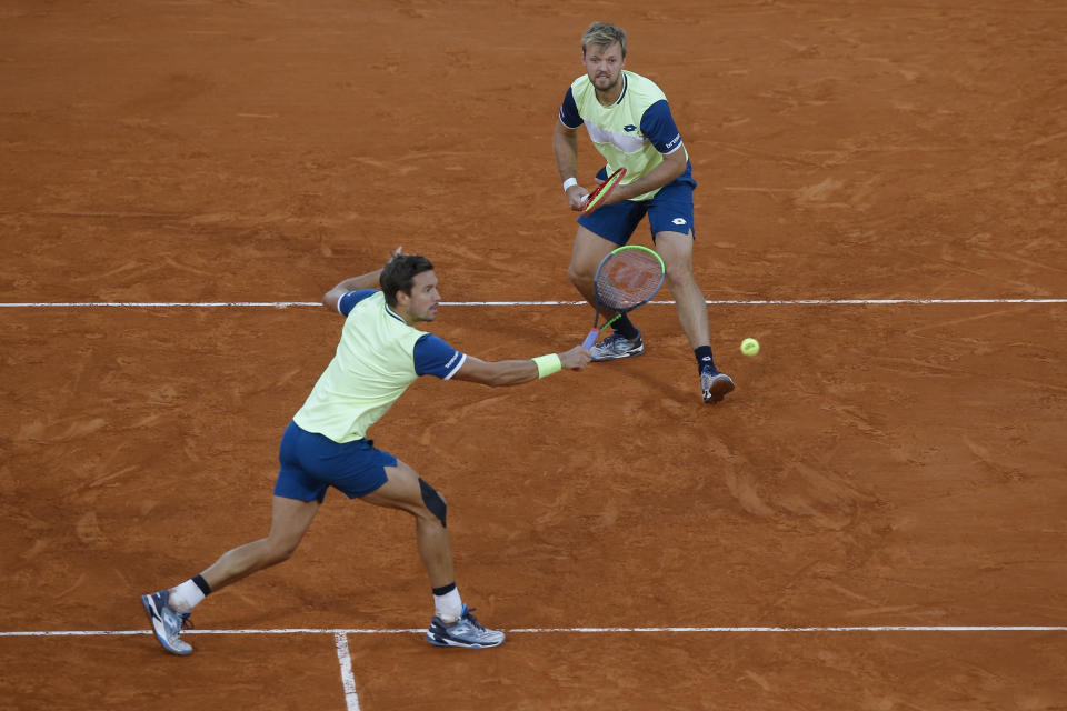 Kevin Krawietz, right, and Andreas Mies of Germany play a shot against Croatia's Mate Pavic and Brazil's Bruno Soares in the men's doubles final match of the French Open tennis tournament at the Roland Garros stadium in Paris, France, Saturday, Oct. 10, 2020. (AP Photo/Michel Euler)