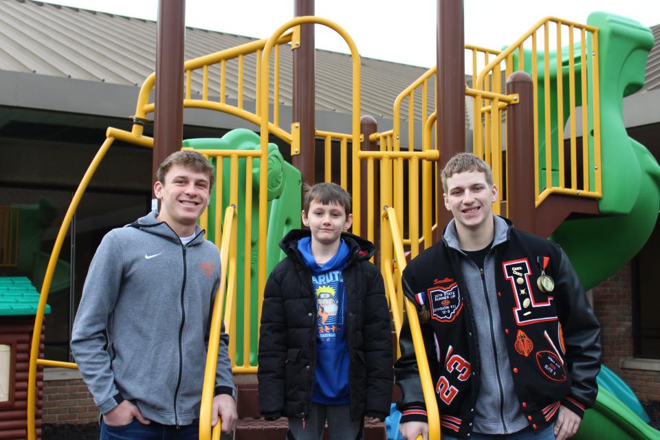 Lucas' Corbin Toms (left) and Andrew Smollen (right) pose for a photo with this year's All-Star Classic Poster Child, Klayton, in the courtyard of Catalyst Life Services. Klayton and his family will be in attendance in the front row for the 44th News Journal All-Star Classic at 7:30 p.m. on Friday night at Lexington High School. All proceeds from the game are donated to Catalyst Life Services and will benefit the Child and Adolescent Mental Health and Crisis Services department.