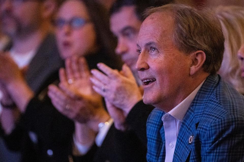 Attorney General Ken Paxton listens as supporters applaud him at the campaign event for Tom Glass on Jan. 24.