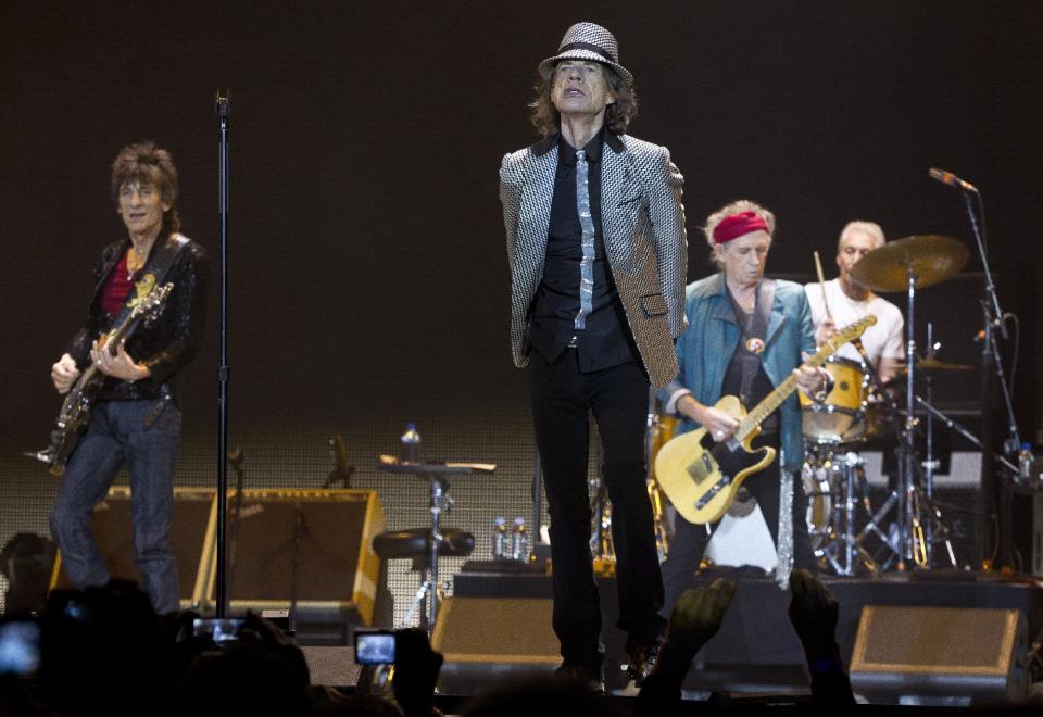 Mick Jagger, center, Keith Richards, Ronnie Wood, left, and Charlie Watts, right, of The Rolling Stones perform at the O2 arena in east London, Sunday, Nov. 25, 2012. The band are playing four shows to celebrate their 50th anniversary, including two shows at London’s O2 and two more in New York. (Photo by Joel Ryan/Invision/AP)