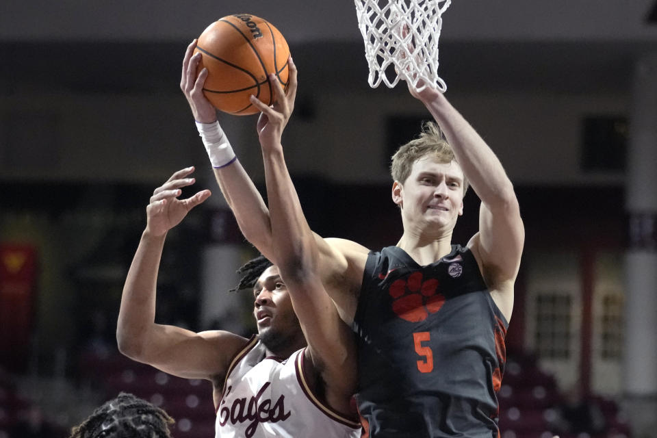 Clemson forward Hunter Tyson (5) grabs a rebound against Boston College forward Devin McGlockton, left, during the second half of an NCAA college basketball game, Tuesday, Jan. 31, 2023, in Boston. (AP Photo/Charles Krupa)