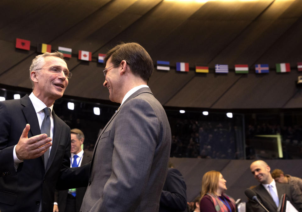 U.S. Secretary for Defense Mark Esper, second left, speaks with NATO Secretary General Jens Stoltenberg, left, during a meeting of the North Atlantic Council at NATO headquarters in Brussels, Thursday, Feb. 13, 2020. NATO ministers, in a second day of meetings, will discuss building stability in the Middle East, the Alliance's support for Afghanistan and challenges posed by Russia's missile systems. (AP Photo/Virginia Mayo)