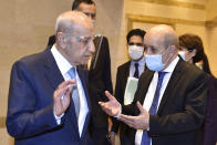 In this photo released by the Lebanese Parliament media office, Lebanese French Foreign Minister Jean-Yves Le Drian, right, speaks with Lebanese Parliament Speaker Nabih Berri, in Beirut, Lebanon, Thursday, May 6, 2021. Le Drian began a visit to Lebanon Thursday with a message of "great firmness" to its political leaders, threatening to take additional measures against officials obstructing the formation of a government in the crisis-hit country. (AP Photo/ Hassan Ibrahim, Lebanese Parliament media office)