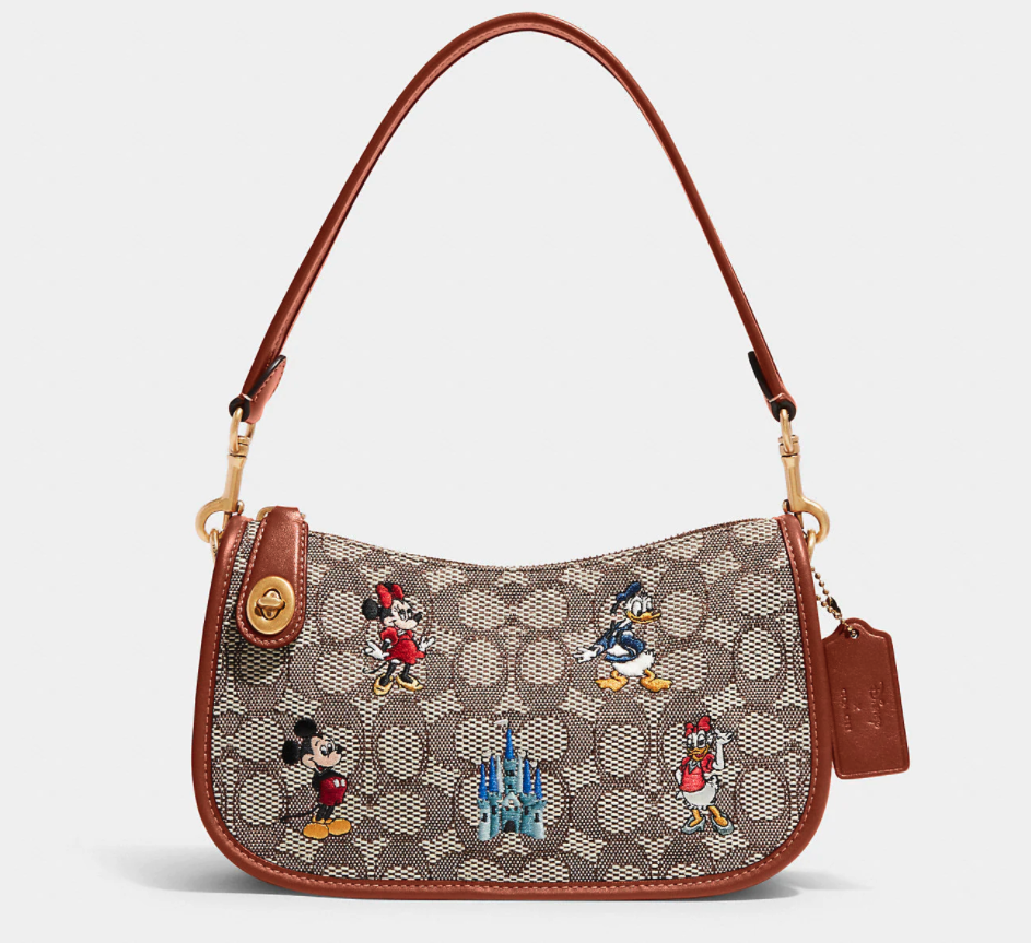 Disney X Coach Swinger Bag In Signature Textile Jacquard With Mickey Mouse And Friends Embroidery. Image via Coach.