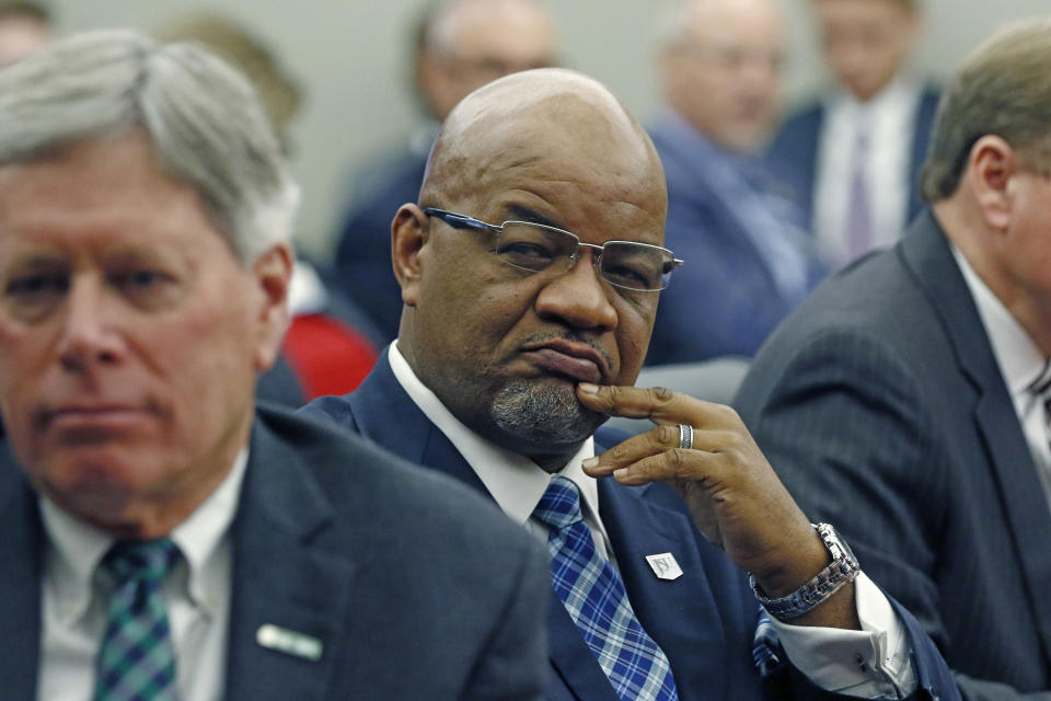 This is a Jan. 16, 2020 photograph of then president of Jackson State University, William Bynum Jr., 57, right, at a college board meeting in Jackson, Miss. Bynum resigned effective immediately, Monday, Feb. 10, 2020, after he was arrested during the weekend in a prostitution sting in Clinton, Miss. The former president was among more than a dozen people arrested during the weekend. He is charged with procuring services of a prostitute, false statement of identity and simple possession of marijuana. (AP Photo/Rogelio V. Solis)