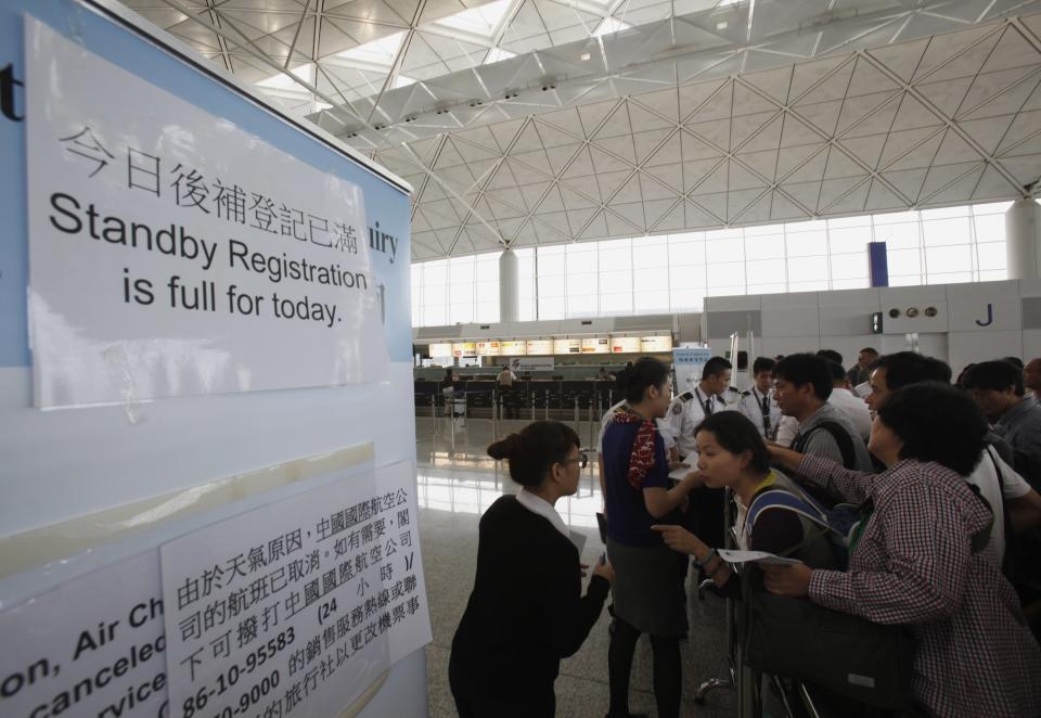 Passengers wait for their departure at Hong Kong Airport after Typhoon Usagi, the strongest storm to hit the Western Pacific this year, swiped Hong Kong