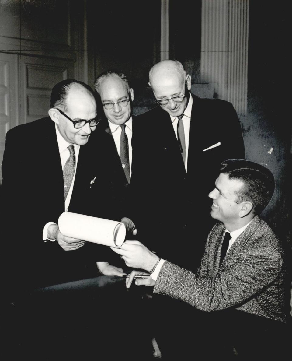 Lt. Gov. George Nigh, right, signs the first law of the current legislative session on Jan. 20, 1961. With him are, from left, Morris Leonhard, Laymond Crump and Rep. Jim Bullard.